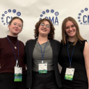 Three students at CMA Spring Convention step and repeat