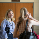 Spring Forward - two women speak in a Walker Hall hallway